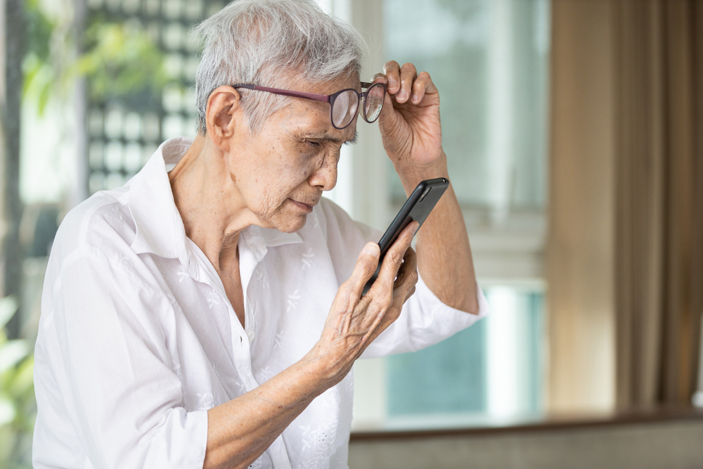 women with eye glasses try to read